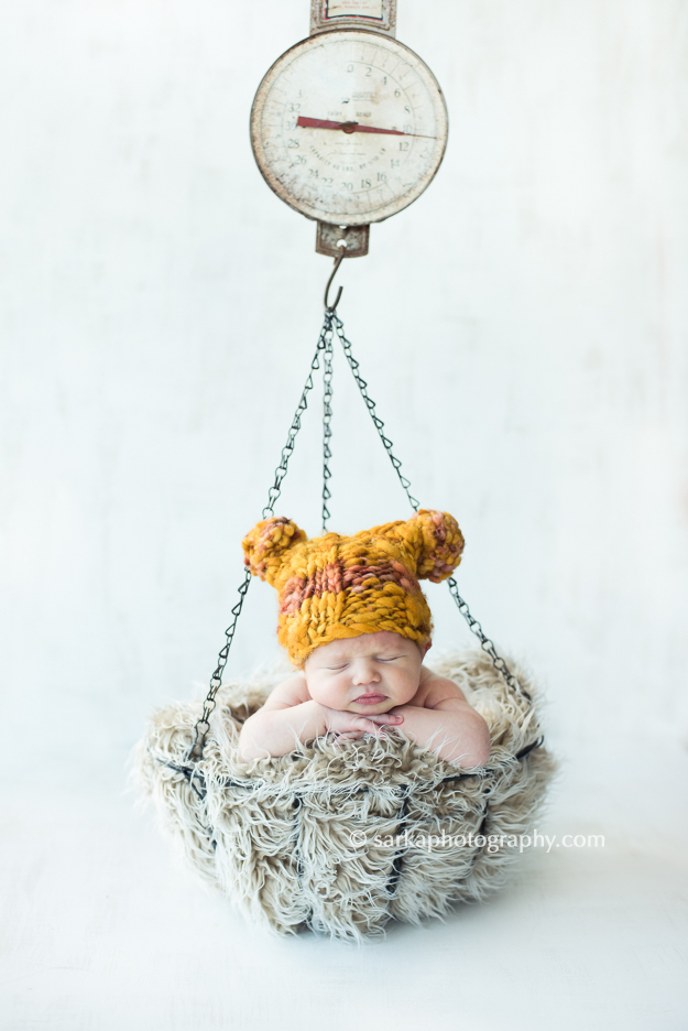 newborn boy sleeping in a vintage scale photographed by santa barbara and san francisco baby photographer 