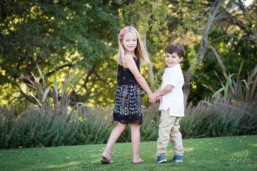 young siblings holding hands during their children portrait session by bay area burlingame family photographer sarkaphotography