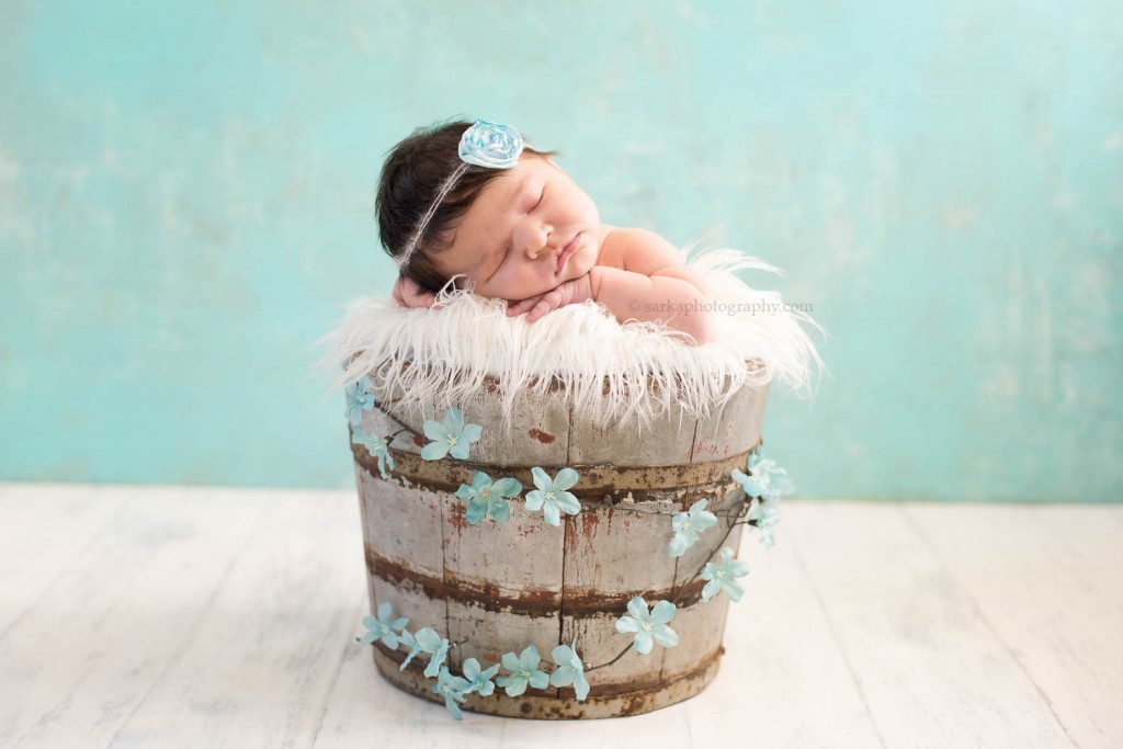 newborn baby girl sleeping in a vintage bucket photographed by Santa Barbara newborn photographer sarkaphotography