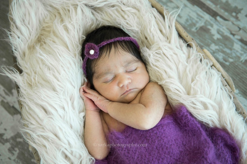 newborn baby girl sleeping in a purple knitted wrap photographed by San Francisco Bay Area and Santa Barbara baby photographer sarkaphotography