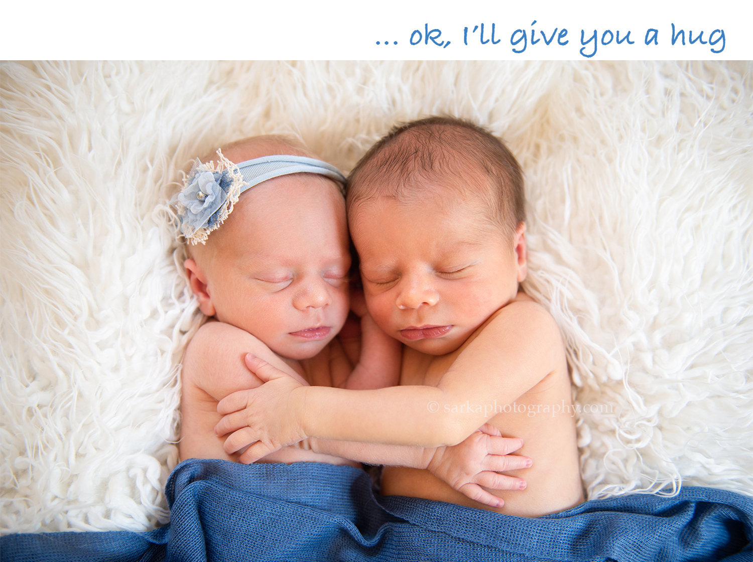 newborn twins hugging each other during their newborn photo session in Santa Barbara