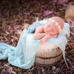 newborn baby sleeping in a wood bucket with photographed by San Francisco Bay Area and Santa Barbara baby photographer Sarka Photography