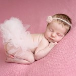 newborn baby girl sleeping on a pink blanket with a pink tutu photographed by San Francisco Bay Area and Santa Barbara baby photographer Sarka Photography