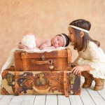 newborn baby girl and her sister with vintage suitcases photographed by San Francisco Bay Area and Santa Barbara baby photographer Sarka Photography
