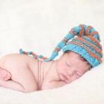 newborn baby boy sleeping in a hand knitted striped hat photographed by San Francisco Bay Area and Santa Barbara baby photographer Sarka Photography