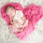 newborn baby sleeping in a heart shaped scarf photographed by San Francisco Bay Area and Santa Barbara baby photographer Sarka Photography