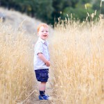 little boy smiling in a golden grassy path photographed by Santa Barbara and San Francisco Bay area photographer Sarka Photography