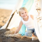 little girl peeking from a beach tent photographed by Santa Barbara and San Francisco Bay area photographer Sarka Photography