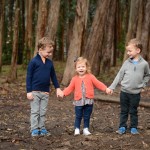 siblings holding hands in a woodsy photographed by Santa Barbara and San Francisco Bay area photographer Sarka Photography