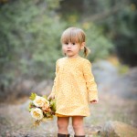 little girl holding flowers in a park photographed by Santa Barbara and San Francisco Bay area photographer Sarka Photography