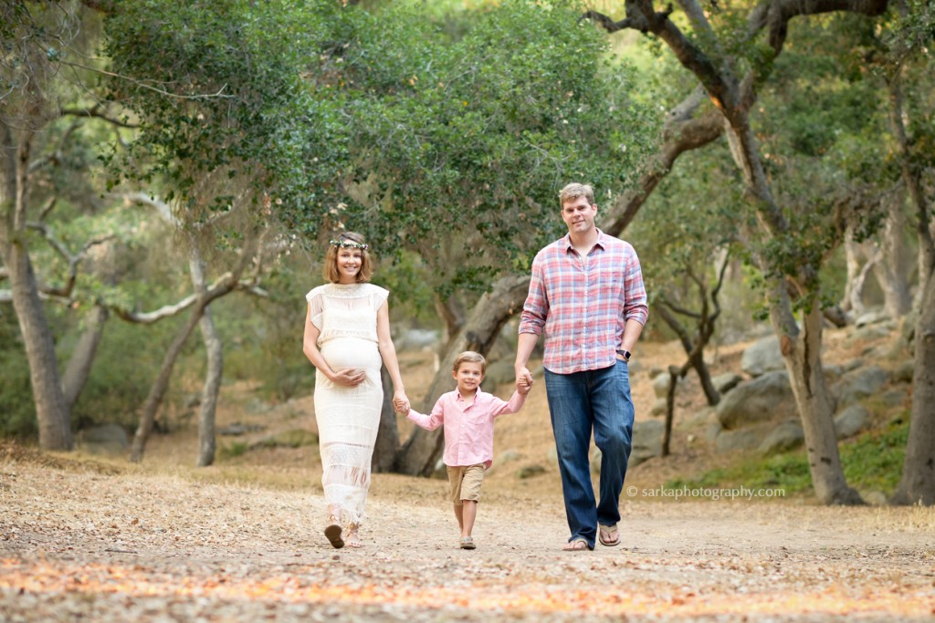 young family walking in a oak tree park photographed by Santa Barbara family photographer Sarka Photography