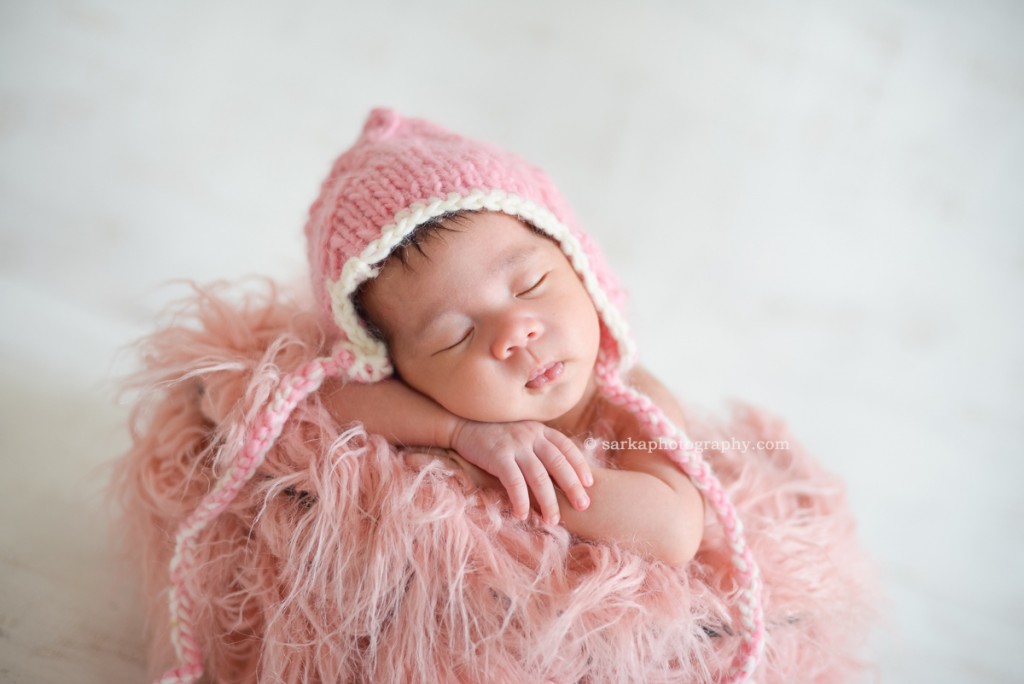 newborn baby girl sleeping wearing hand knitted pink hat photographed by Santa Barbara and San Francisco Bay area photographer Sarka
