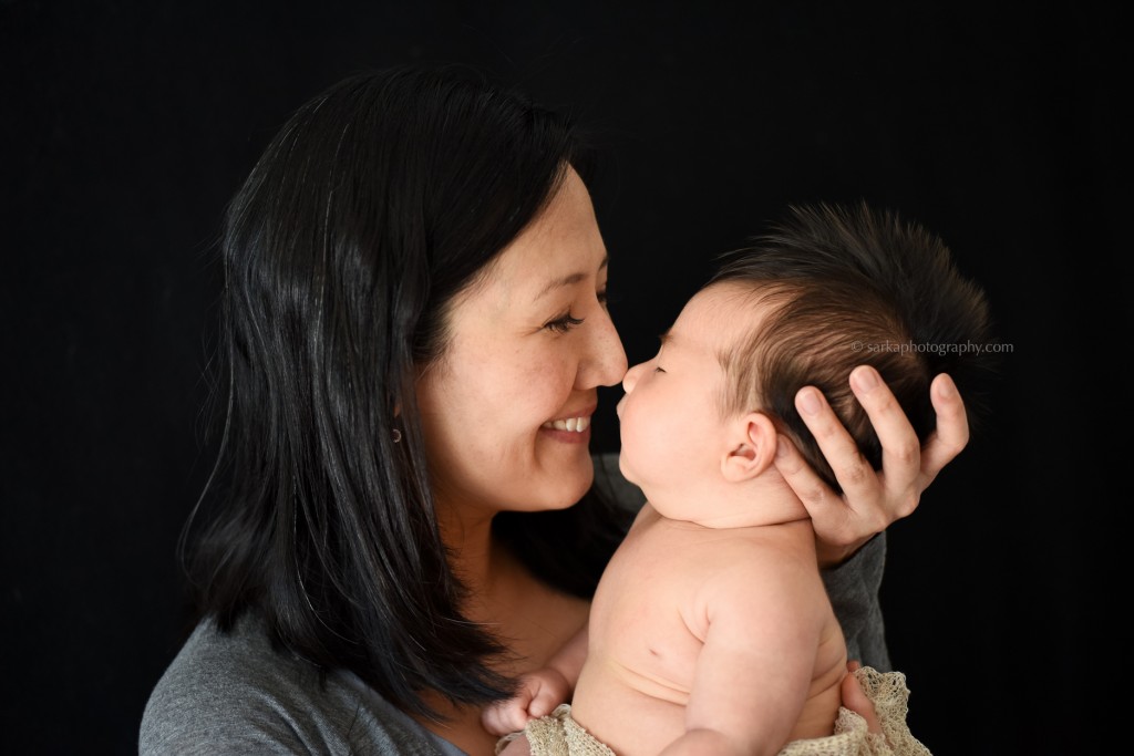 new mom holding his baby boy son baby boy in a wooden box photographed by Santa Barbara and Burlingame baby photographer Sarka Photography